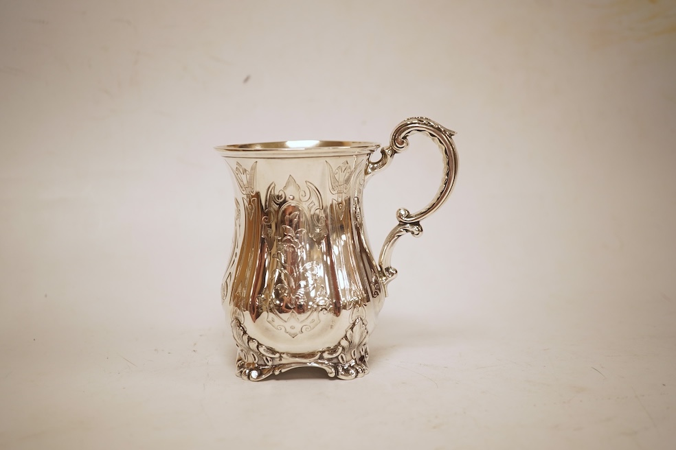 A Victorian engraved silver christening mug, with acanthus leaf capped scroll handle and engraved inscription, Martin, Hall & Co, Sheffield, 1856, 11cm, 5.3oz.